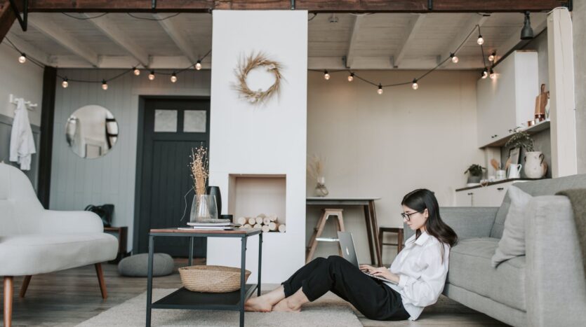 woman sitting on the floor using a laptop