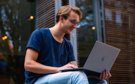 selective focus photo of man using laptop