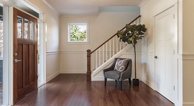 Armchair and tree in house entryway