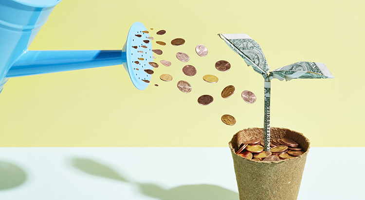 Origami dollar seedling being watered with coins