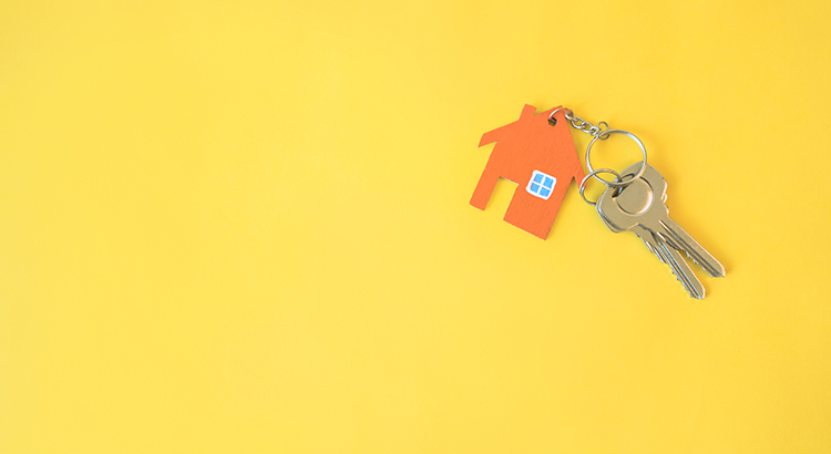 House and key on yellow background. Minimal creative style.