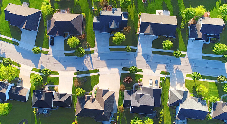 Looking straight down on beautiful suburban homes, Springtime aerial view.