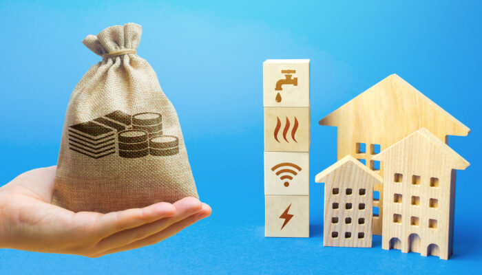 Money bag, residential buildings and blocks with communal services symbols. Utilities public service. Price, payment methods, subsidies registration. Savings, reduced environmental impact.