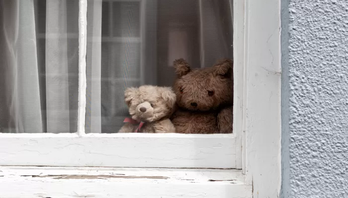 Teddy bears sitting at the window