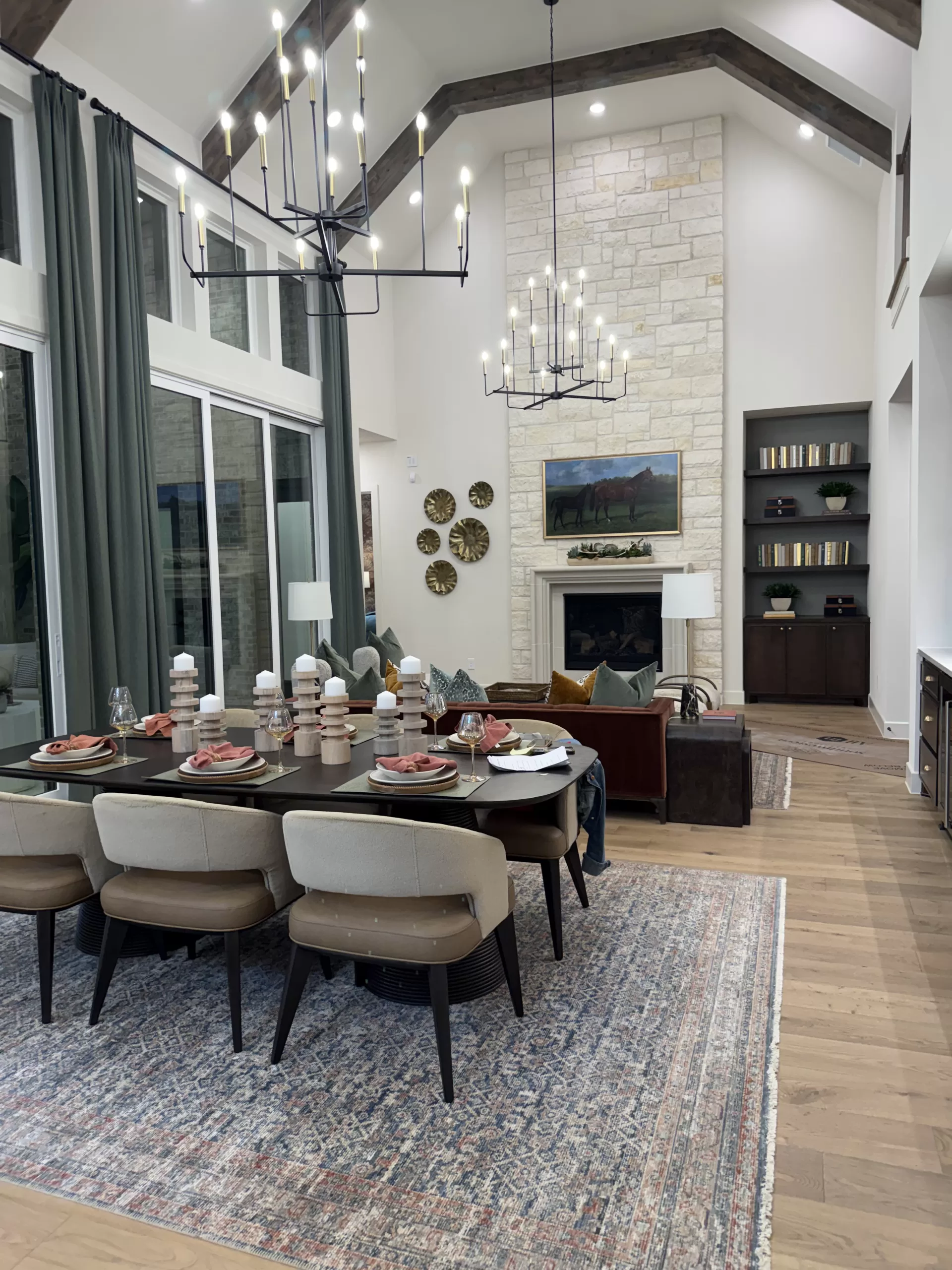 Highland Homes Furst Ranch Flower Mound TX kitchen with vaulted ceiling, wood beams, large island, and dark cabinetry.