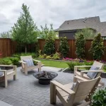 Outdoor living space at a David Weekley Homes model in Furst Ranch, featuring a landscaped backyard, paver patio, fire pit seating area, and private fenced yard near Flower Mound and Bartonville, TX.