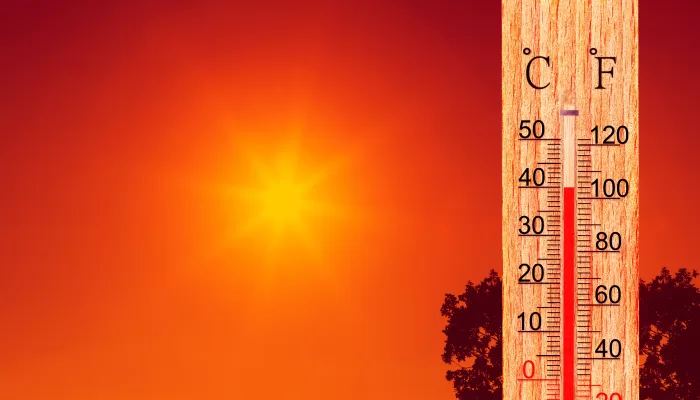 Summer heat. Thermometer display plus 40 degrees celsius. Orange sun in red sky